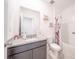 Bathroom with granite countertop, grey cabinets, and shower with floral curtains at 3451 Monaco Ln, Davenport, FL 33897