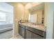 Bathroom featuring double sinks with granite countertop and view of bedroom at 3451 Monaco Ln, Davenport, FL 33897