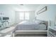 Bedroom featuring a bed with gray comforter, carpeted floor, and desk at 3451 Monaco Ln, Davenport, FL 33897
