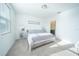 Bright bedroom featuring a bed with gray comforter and ensuite bathroom at 3451 Monaco Ln, Davenport, FL 33897