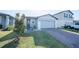 Attractive single-story house with brick paved driveway, lawn, and landscaped front yard at 3451 Monaco Ln, Davenport, FL 33897