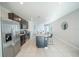 Open kitchen boasts stainless steel appliances, a large island with seating, and dark cabinetry at 3451 Monaco Ln, Davenport, FL 33897