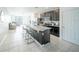 Stylish kitchen with stainless steel appliances, center island, and open layout to living area at 3451 Monaco Ln, Davenport, FL 33897