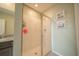 Shower with glass door, white tiles and toiletry storage at 3451 Monaco Ln, Davenport, FL 33897