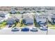 Street view of homes with neat landscaping and parked vehicles, showing neighborhood charm and curb appeal at 3451 Monaco Ln, Davenport, FL 33897