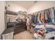 Walk-in closet with dark drawers and clothes hanging on metal rails at 3451 Monaco Ln, Davenport, FL 33897