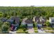 Overhead view captures neighboring houses and the property's layout, complete with lush greenery and surrounding woodland at 3890 Prairie Reserve Blvd, Orlando, FL 32824