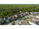 An aerial view displays a well-planned residential neighborhood surrounded by nature and lush green forest at 3890 Prairie Reserve Blvd, Orlando, FL 32824