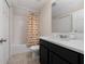 Bathroom features shower-tub combo with owl themed shower curtain and modern vanity at 3890 Prairie Reserve Blvd, Orlando, FL 32824