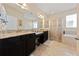 Bright bathroom with double vanity, granite countertops, and glass enclosed shower at 3890 Prairie Reserve Blvd, Orlando, FL 32824