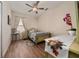 Charming bedroom featuring wood floors, a decorative bed, and matching furniture at 3890 Prairie Reserve Blvd, Orlando, FL 32824