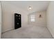 Spacious, carpeted bedroom with shelving, overhead lighting, and a large window at 3890 Prairie Reserve Blvd, Orlando, FL 32824