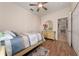 A cozy bedroom featuring wood floors, neutral walls, and a ceiling fan at 3890 Prairie Reserve Blvd, Orlando, FL 32824
