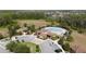 Aerial shot of a community pool featuring covered seating areas, palm trees, and ample lounge chairs at 3890 Prairie Reserve Blvd, Orlando, FL 32824