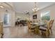 Formal dining room with glass-top table, chandelier, and seamless access to the living room at 3890 Prairie Reserve Blvd, Orlando, FL 32824