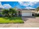 Charming single-Gathering home featuring a two-car garage and well-manicured lawn, complete with lush tropical landscaping at 3890 Prairie Reserve Blvd, Orlando, FL 32824