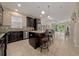 Open kitchen with dark cabinets, granite countertops, stainless steel appliances, and an island bar at 3890 Prairie Reserve Blvd, Orlando, FL 32824