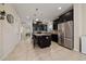 Open kitchen with dark cabinets, granite countertops, stainless steel appliances, and a center island at 3890 Prairie Reserve Blvd, Orlando, FL 32824