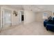 Open living room with carpet, showing access to the bathroom and bedroom at 3890 Prairie Reserve Blvd, Orlando, FL 32824