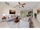 Inviting living room with a ceiling fan, neutral colors, tile flooring, and comfortable seating arrangement at 3890 Prairie Reserve Blvd, Orlando, FL 32824