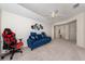Large living room with carpet, ceiling fan, and a blue sofa at 3890 Prairie Reserve Blvd, Orlando, FL 32824