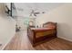 Main bedroom featuring wood floors, a ceiling fan, and a dedicated workspace at 3890 Prairie Reserve Blvd, Orlando, FL 32824