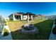 Beautifully landscaped backyard with gazebo, fire pit, and green space for outdoor enjoyment and relaxation at 400 Chayne Pl, St Cloud, FL 34771