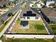 Aerial view of a fenced backyard with a gazebo, artificial grass, and solar panels on the home's roof at 400 Chayne Pl, St Cloud, FL 34771