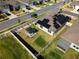 Aerial view of a fenced backyard featuring a gazebo, fire pit, and solar panels on the home's roof at 400 Chayne Pl, St Cloud, FL 34771