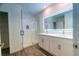 Bathroom features dual sinks, lighted mirror, an enclosed glass shower, and tile flooring at 400 Chayne Pl, St Cloud, FL 34771