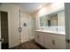 Well-lit bathroom boasts dual vanity, a walk-in glass shower, and modern tile flooring at 400 Chayne Pl, St Cloud, FL 34771