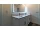 Contemporary bathroom features dual sinks, a vanity with storage, and a large lighted mirror at 400 Chayne Pl, St Cloud, FL 34771