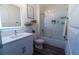 Bathroom with a vanity, decorative shelves, and a shower/tub combo with sliding glass doors at 400 Chayne Pl, St Cloud, FL 34771