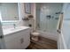 Bathroom with a vanity, decorative shelves, and a shower/tub combo with sliding glass doors at 400 Chayne Pl, St Cloud, FL 34771