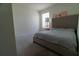 Bedroom with a queen sized bed next to a display cabinet, and a window with shades at 400 Chayne Pl, St Cloud, FL 34771