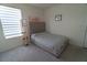 Bedroom with a queen sized bed next to a display cabinet, and a window with shades at 400 Chayne Pl, St Cloud, FL 34771