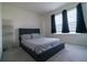 Bedroom with a queen sized bed, and gray blackout shades over the windows at 400 Chayne Pl, St Cloud, FL 34771