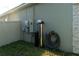 Exterior view of the water filtration system and electrical boxes installed on the side of the house at 400 Chayne Pl, St Cloud, FL 34771