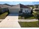 Well-manicured lawn, modern architectural features, and a two-car garage add curb appeal to this single-Gathering home at 400 Chayne Pl, St Cloud, FL 34771