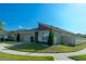 View of a single-story house with a driveway, two-car garage and manicured lawn with well-maintained landscaping at 400 Chayne Pl, St Cloud, FL 34771