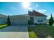 Inviting single-story home boasts stone accents, well-maintained landscaping, and an attached two-car garage at 400 Chayne Pl, St Cloud, FL 34771