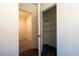 Hallway showing entry to a small bedroom with carpet on the left, and a walk in closet on the right at 400 Chayne Pl, St Cloud, FL 34771