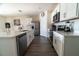 Bright kitchen with stainless steel appliances, white subway tile backsplash, island with sink, and wood-look flooring at 400 Chayne Pl, St Cloud, FL 34771