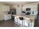 Modern kitchen features an island with seating, stainless steel appliances, quartz countertops, and wood-look flooring at 400 Chayne Pl, St Cloud, FL 34771
