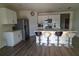 Bright modern kitchen features white cabinetry, stainless steel appliances, and a breakfast bar with seating at 400 Chayne Pl, St Cloud, FL 34771