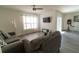 Comfortable living room with a ceiling fan, large window, and a mounted flat screen television at 400 Chayne Pl, St Cloud, FL 34771