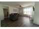 Cozy living room featuring modern flooring, neutral paint, a large window, and recessed lighting at 400 Chayne Pl, St Cloud, FL 34771