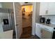 Walk-in pantry with white shelving, seamlessly integrated into a modern kitchen design with white cabinets at 400 Chayne Pl, St Cloud, FL 34771