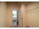 This walk in closet has a metal shelving rack and an entry view of a bathroom with a single sink at 400 Chayne Pl, St Cloud, FL 34771