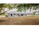 Expansive backyard with patio, outdoor seating, and manicured lawn offers a perfect space for relaxation and entertainment at 4091 Lippman Rd, St Cloud, FL 34772
